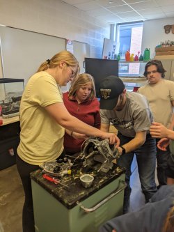 Agricultural educator works with students on small engines